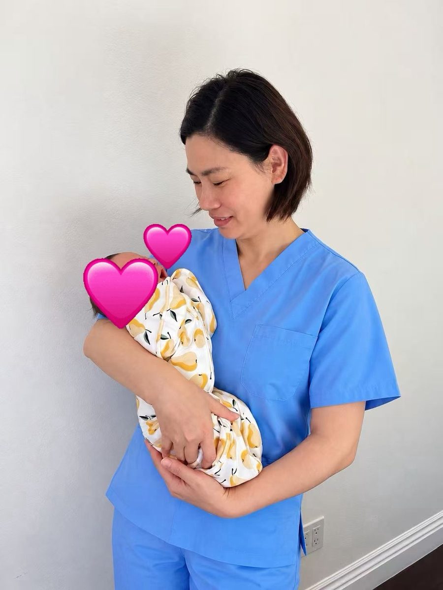 Ivy holding a newborn