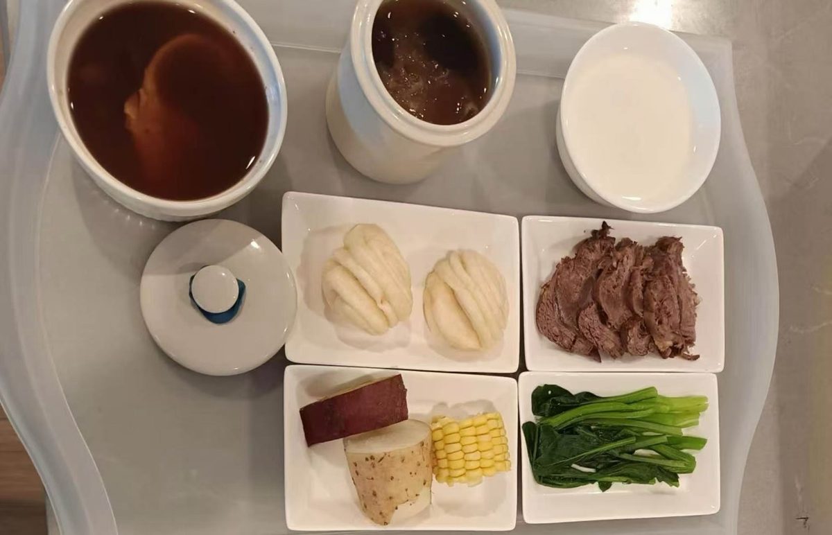 Postpartum meal tray with soups, buns and dishes